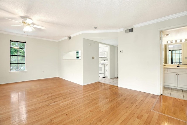 unfurnished room featuring ceiling fan, ornamental molding, light hardwood / wood-style floors, and a textured ceiling