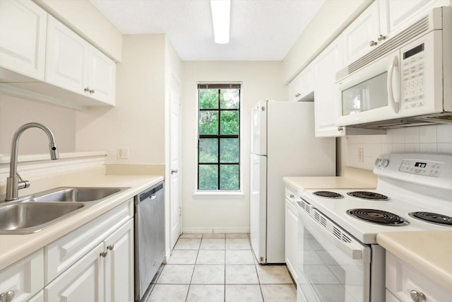 kitchen with a wealth of natural light, white appliances, and white cabinetry