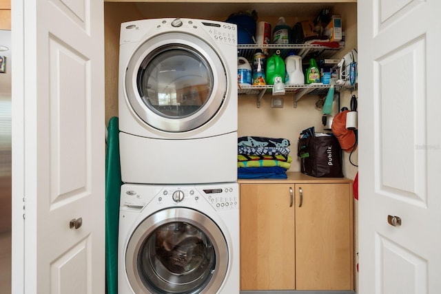 clothes washing area featuring stacked washer / drying machine