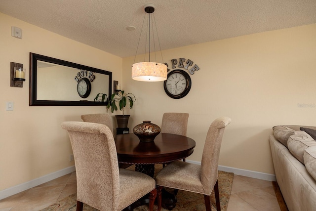 dining area with tile flooring and a textured ceiling