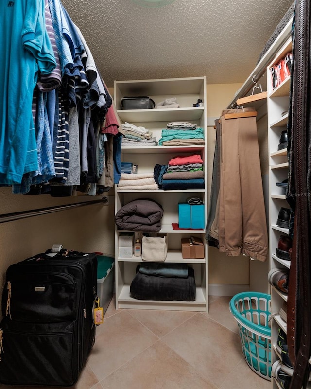 spacious closet featuring tile flooring