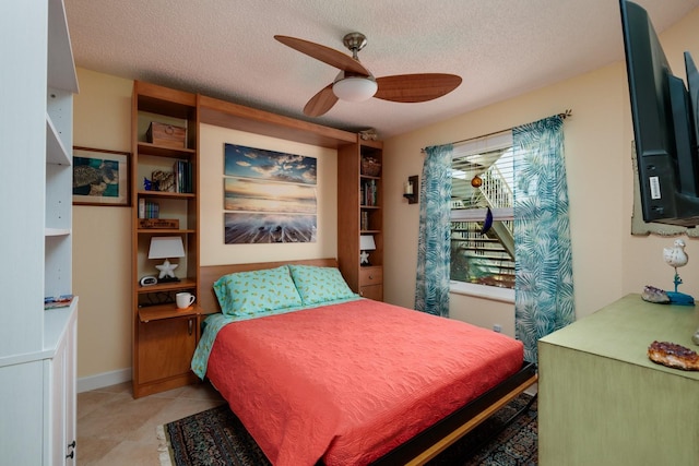 tiled bedroom with ceiling fan and a textured ceiling