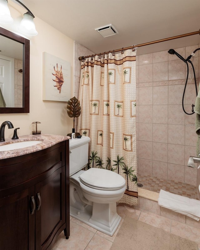 bathroom featuring tile floors, a shower with shower curtain, vanity, and toilet