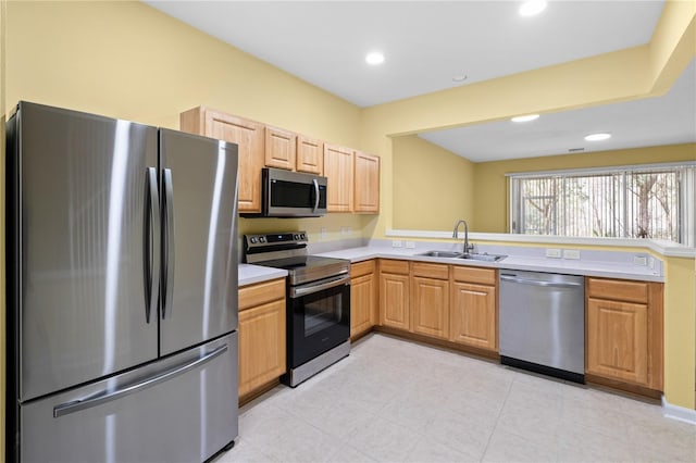 kitchen featuring appliances with stainless steel finishes, sink, and light tile flooring