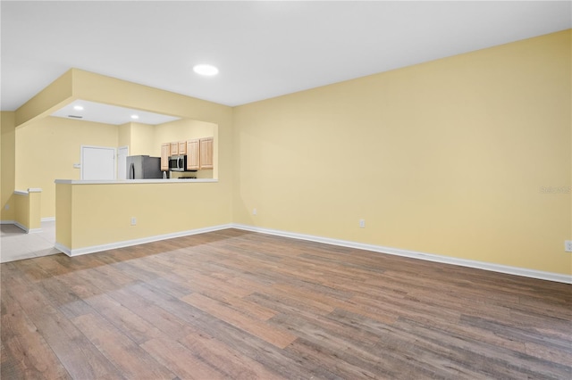 unfurnished living room with hardwood / wood-style flooring