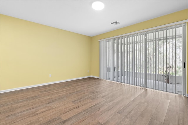 unfurnished room featuring hardwood / wood-style floors