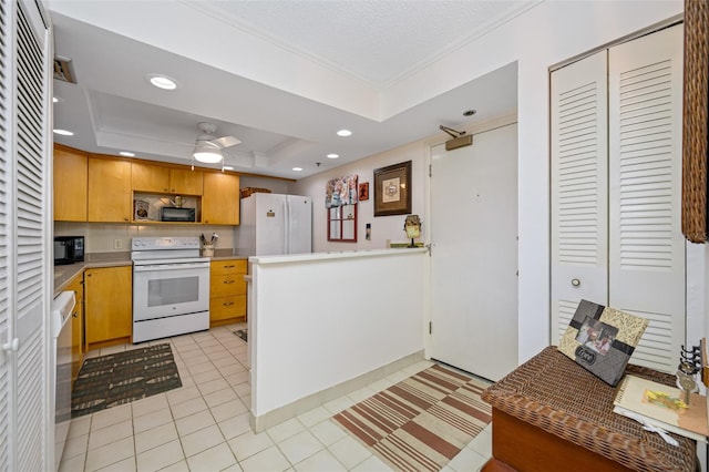 kitchen with crown molding, a textured ceiling, white appliances, a tray ceiling, and light tile patterned flooring