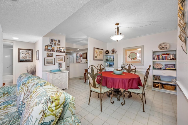 dining space with a textured ceiling