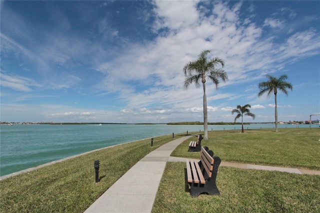 view of property's community featuring a yard and a water view