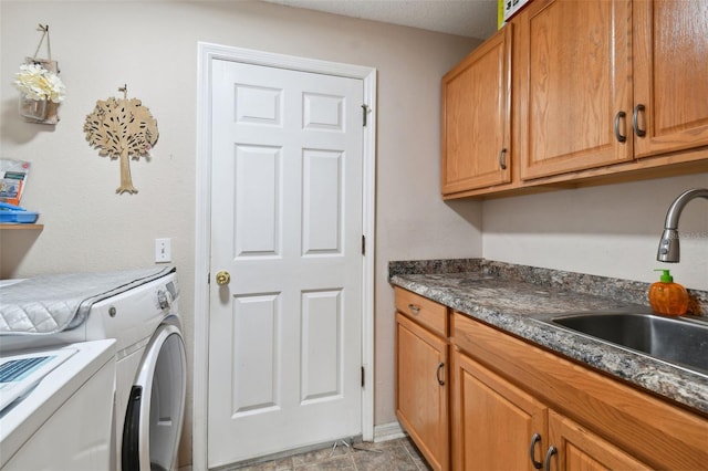 washroom with washing machine and dryer, sink, and cabinets