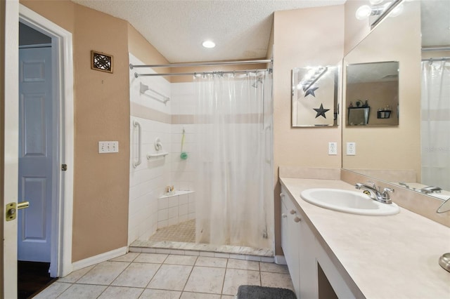 bathroom featuring tile patterned flooring, a shower with curtain, a textured ceiling, and vanity