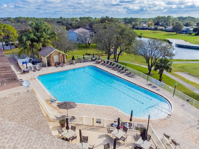 view of pool featuring a patio and a water view