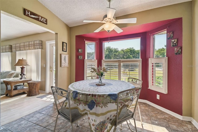 dining space featuring a textured ceiling, tile patterned floors, and ceiling fan