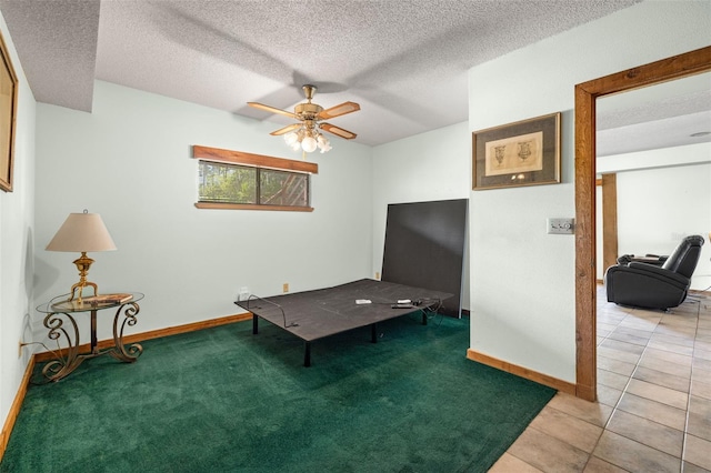 office featuring light tile patterned floors, a textured ceiling, and ceiling fan