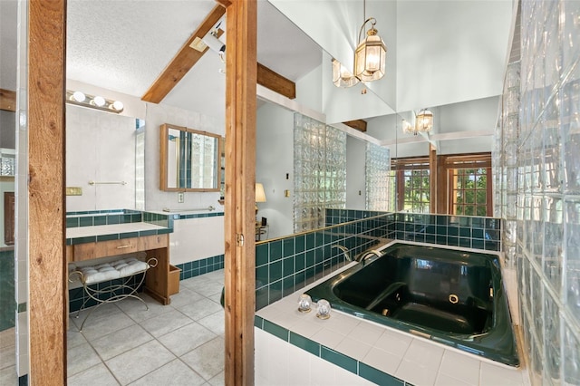 bathroom featuring an inviting chandelier, tile patterned flooring, beamed ceiling, tiled bath, and a textured ceiling