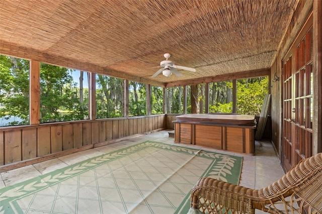 unfurnished sunroom with ceiling fan and wood ceiling