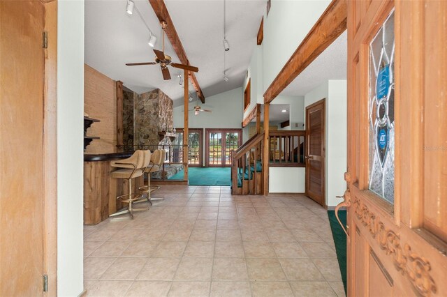 tiled entrance foyer with high vaulted ceiling and ceiling fan