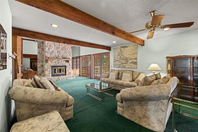 living room featuring a stone fireplace, carpet flooring, ceiling fan, a textured ceiling, and beamed ceiling