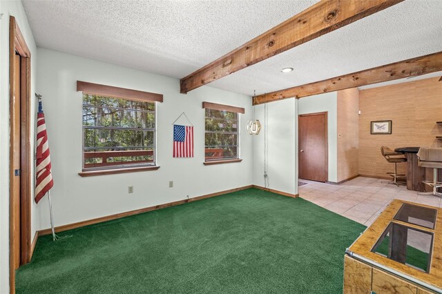 interior space featuring beamed ceiling and a textured ceiling