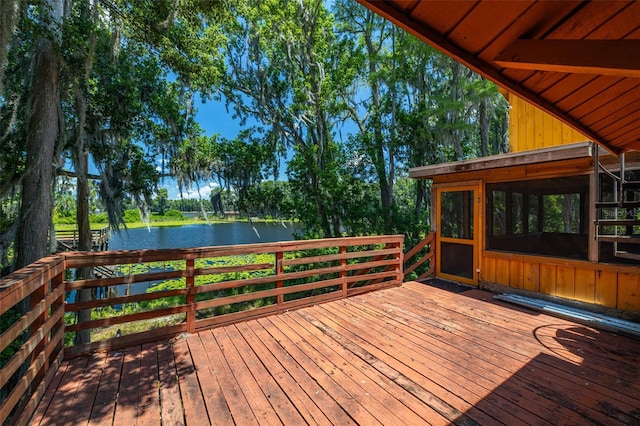 wooden deck with a sunroom and a water view