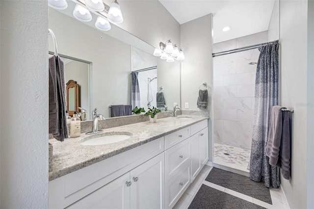 bathroom with tile patterned flooring, vanity, and walk in shower