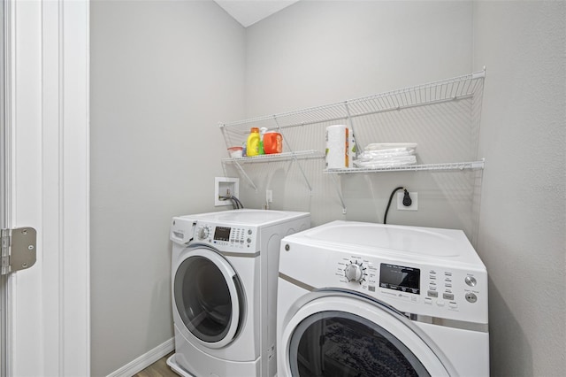 clothes washing area featuring separate washer and dryer