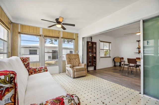 sunroom / solarium featuring ceiling fan and plenty of natural light