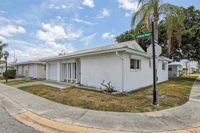 view of front of house with a front yard and a garage