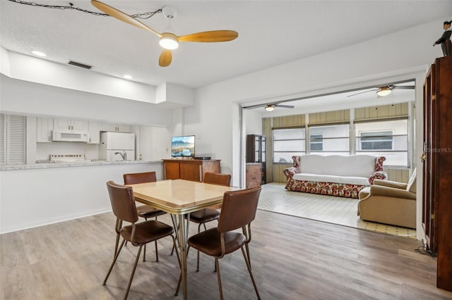 dining space with light wood-type flooring