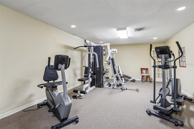 exercise room featuring a textured ceiling