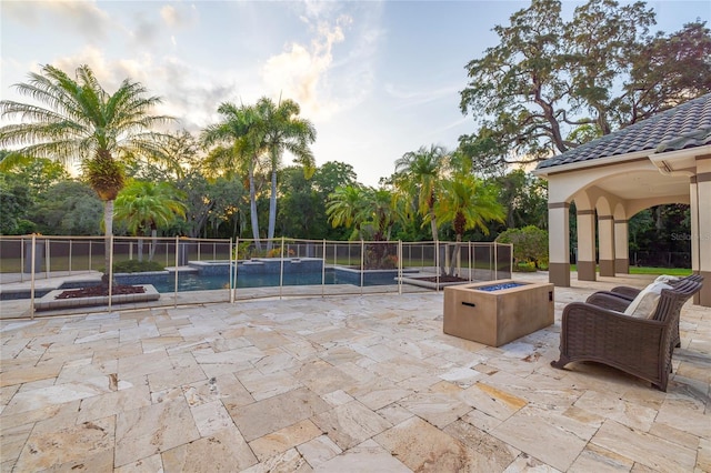 view of patio / terrace featuring a fire pit and a fenced in pool