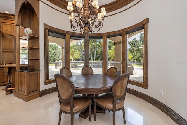 tiled dining area featuring a healthy amount of sunlight, crown molding, and an inviting chandelier