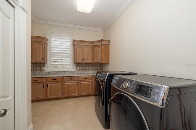 laundry room with cabinets, light tile patterned flooring, ornamental molding, and independent washer and dryer