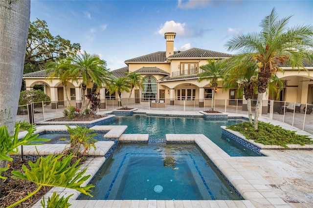 view of pool with a patio area and an in ground hot tub