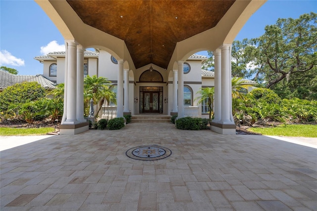 entrance to property featuring a porch and french doors