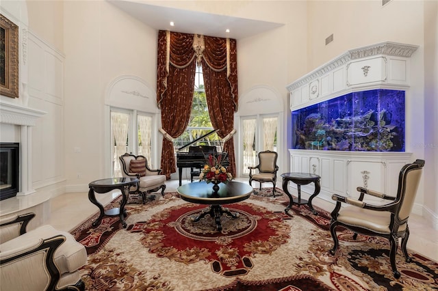 living area featuring a towering ceiling