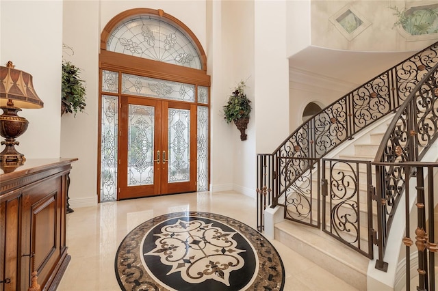 foyer entrance featuring a high ceiling and french doors