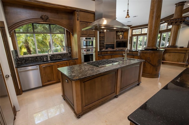 kitchen with sink, an island with sink, a wealth of natural light, island range hood, and stainless steel appliances