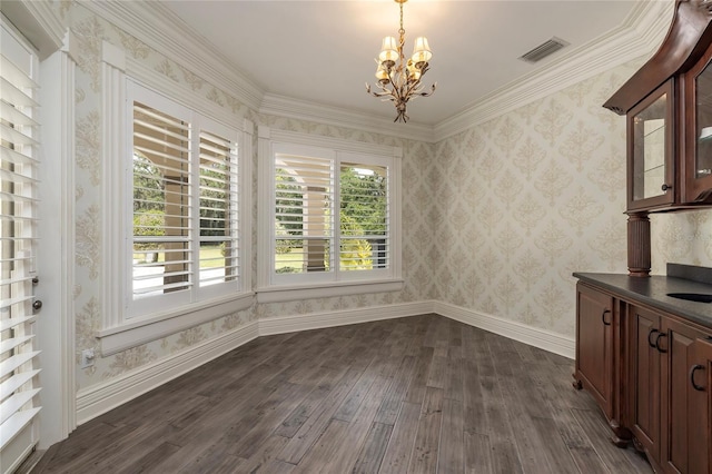 unfurnished dining area with a chandelier, crown molding, and dark wood-type flooring