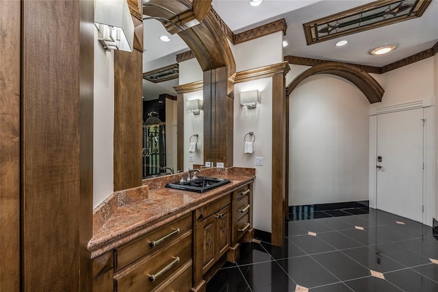 bathroom featuring tile patterned flooring, vanity, and baseboards