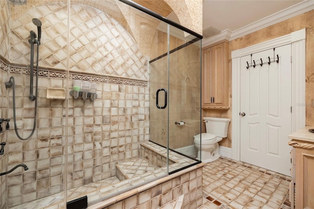 full bathroom with a shower stall, toilet, and crown molding