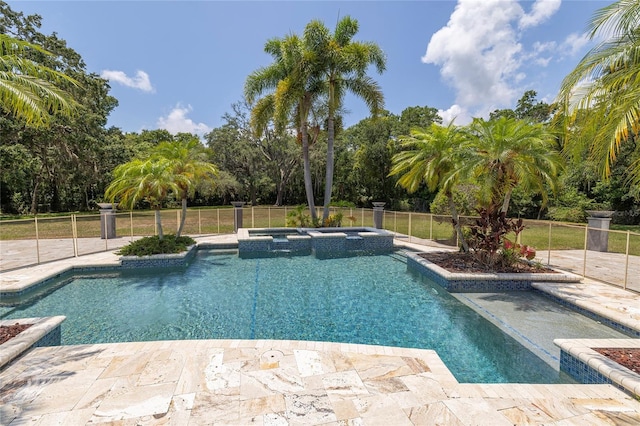 view of swimming pool featuring an in ground hot tub and a patio