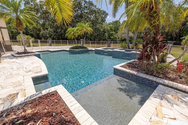 view of swimming pool with an in ground hot tub and a patio