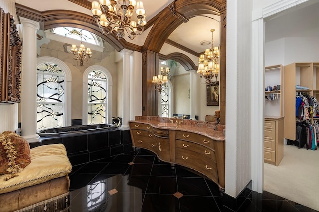 bathroom featuring vanity, tile patterned floors, crown molding, ornate columns, and a chandelier