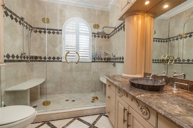 full bathroom with crown molding, toilet, a shower stall, vanity, and ornate columns