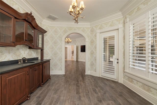 interior space featuring wallpapered walls, visible vents, arched walkways, dark wood finished floors, and a chandelier