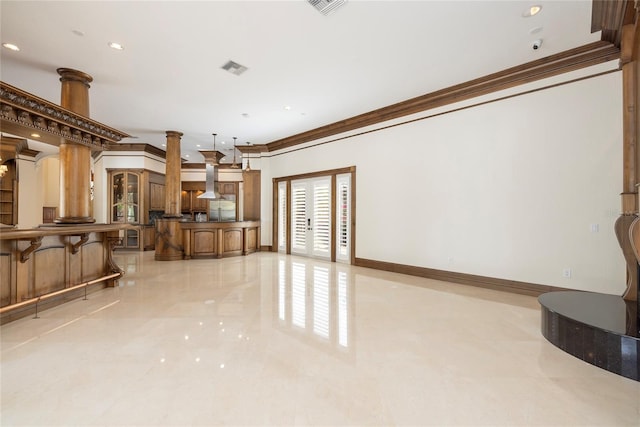 living area with decorative columns, visible vents, baseboards, ornamental molding, and french doors