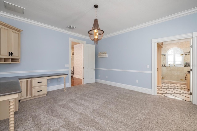 interior space featuring carpet, built in study area, crown molding, and visible vents