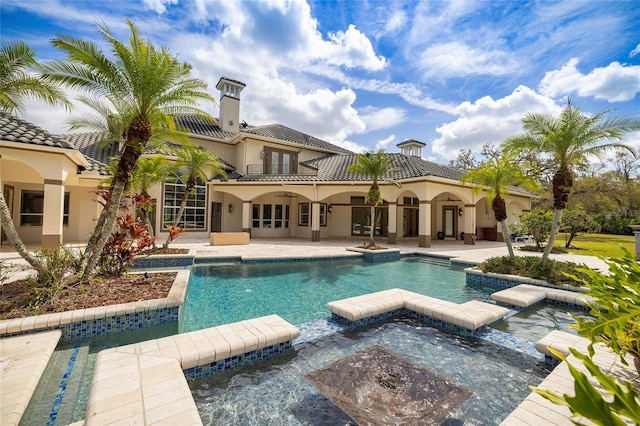 view of pool featuring a pool with connected hot tub, a ceiling fan, french doors, and a patio