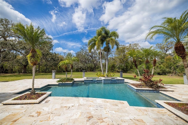 view of swimming pool with a pool with connected hot tub, a patio, and a lawn